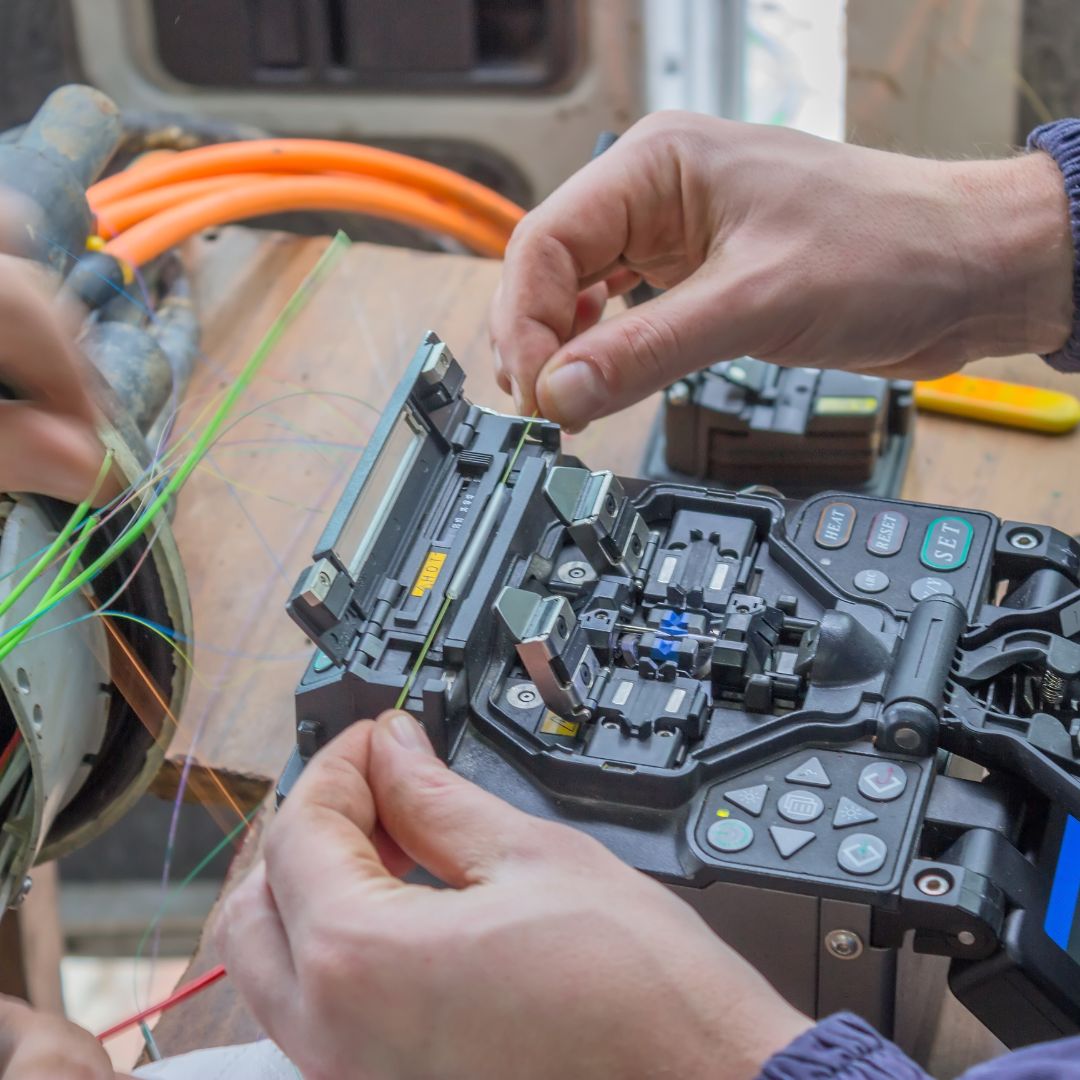 Technician loading fiber into a fusion splicer
