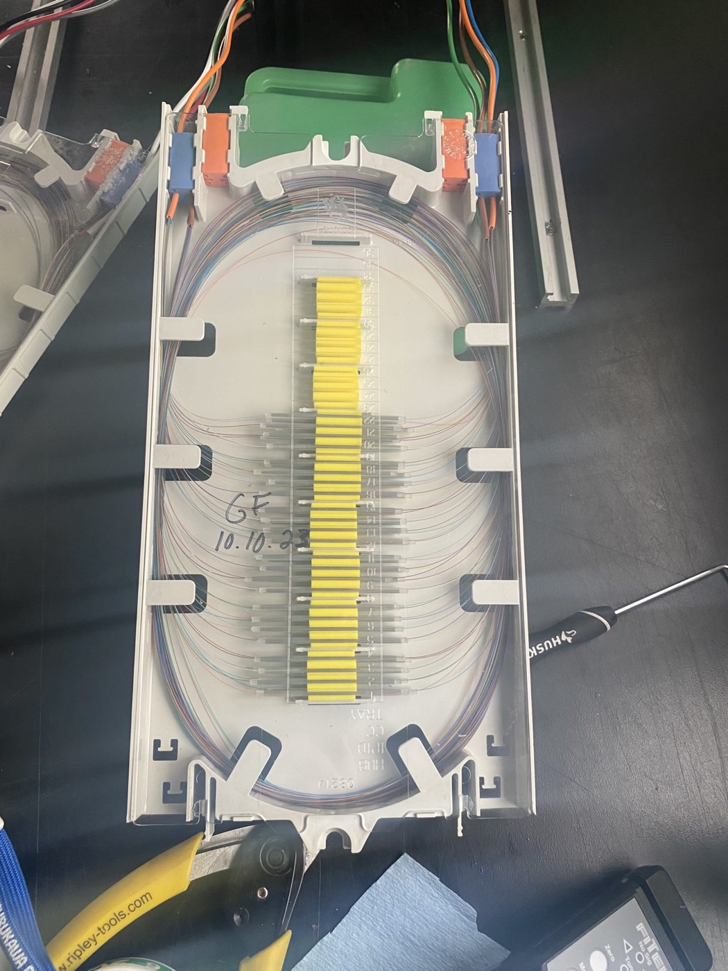 Completed splice tray, each fiber seated in a numbered splice protector